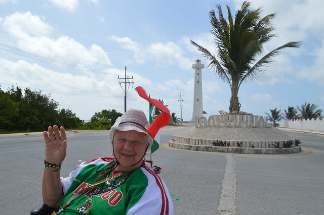 Theresa Irene Wolowski waving hola and the Bandera de México, Mexican flag while visiting Mahahual Village in Costa Maya, Quintana Roo, Yucatán Peninsula, México