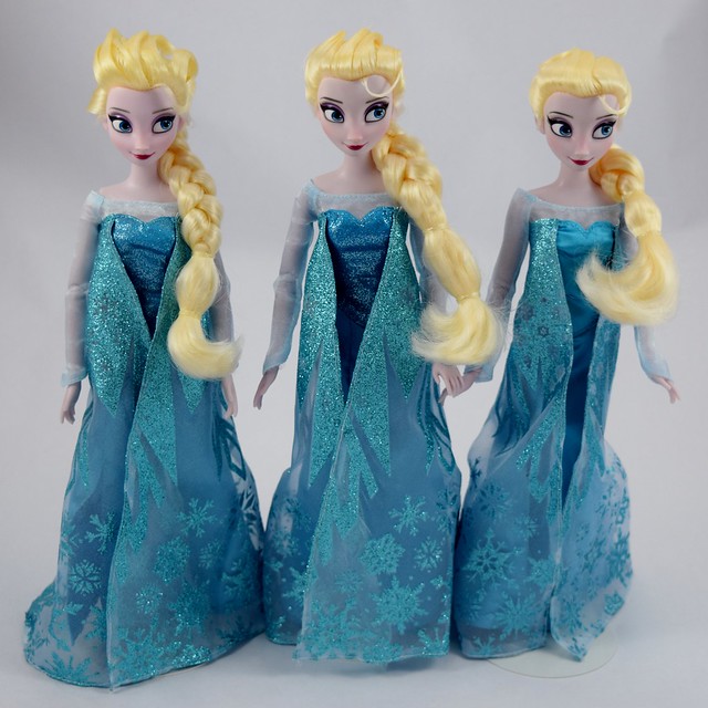 Classic Elsa vs Skating Elsa vs Singing Elsa Dolls - Disney Store - Standing Side by Side - Capes Closed - Full Front View