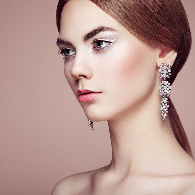 Fashion portrait of young beautiful woman with jewelry