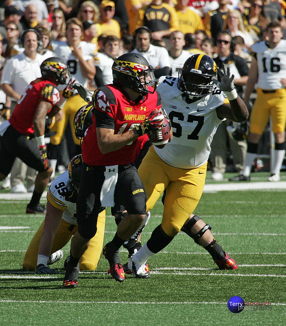 Maryland QB CJ Brown is rushed by DL Jaleel Johnson.