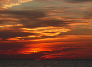 sunset skies over ocean waters