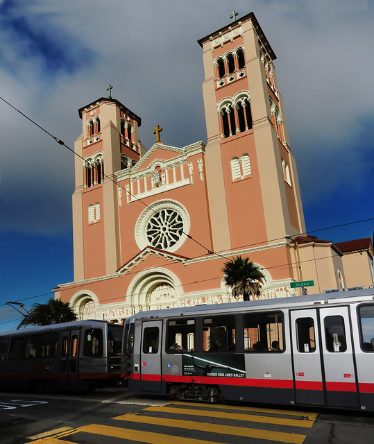 N Judah train passing St. Anne of the Sunset Catholic Church; Judah and Funston St; Inner Sunset, San Francisco (2014)