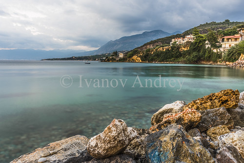 Calm by Ivanov Andrey, Dusk in a quiet Bay on the Greek coast in the village of Kitries.sea ocean coast embankment evening 