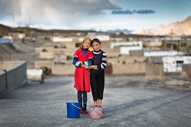 Two Kyrgyz girls standing in a street in Murgab, Tajikistan