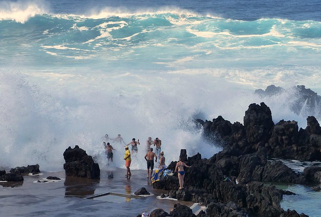 Run like hell!   Dangerous waves at Porto Moniz volcanic rock pools, north-western tip of Madeira.