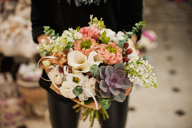 close up of young woman holding bouquet