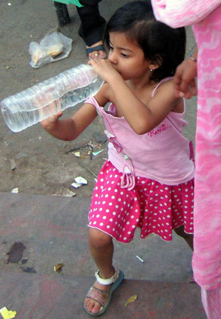Small Child Drinking from Bottle