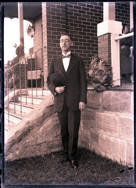 Unidentified man in suit, hat and neck tie.