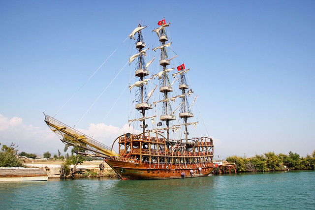 Side - empty docked tourist pirate ship on the river