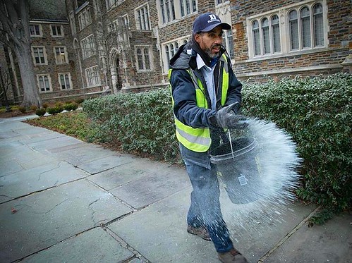Elvis Holden, facilities management landscape specialist, spreads Ice Melter in front of the Old Chemistry Building on Friday morning, Jan. 6, 2017, in anticipation of 6-9 inches of snow expected over the weekend. Photo by Jared Lazarus/Duke Photography.