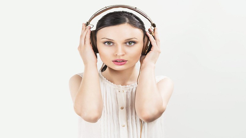 Woman with headphones listening music. Music teenager girl danci