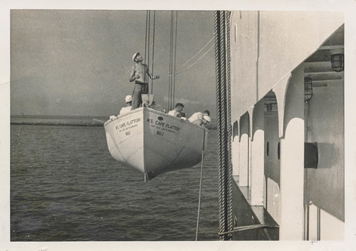 Sailors being lowered in a life boat