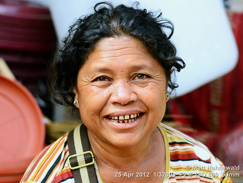 arecanut paan chewingtobacco stainedteeth travel smiling ethnic street portrait cultural character female market posing betelnut eyes face facingtheworld batak indonesia toba woman nikond3100 outdoor sumatra diversity betelstainedteeth lifestyle nikkorafs50mmf18g clarity person closeup fullfaceview matthahnewald headshot colorcolour lookingatviewer colorfulcolourful