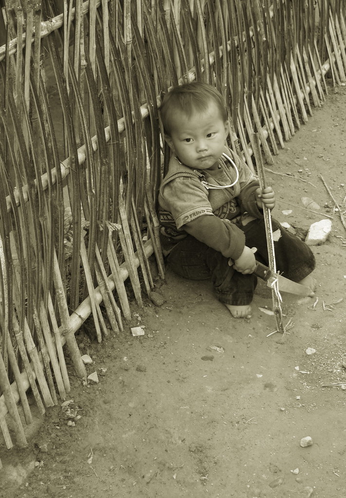 Mind your toes! | A Black Hmong boy sharpening his bamboo - … | Flickr