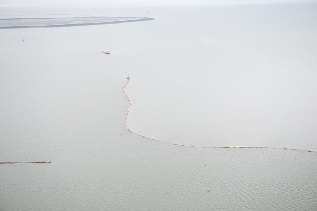 A US Coast Guard photo of a sheen of containment boom deployed after a collision between the Carla Maersk and Conti Peridot in the Houston Ship Channel in March 2015.