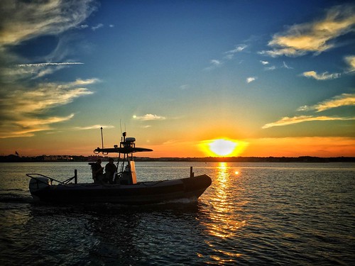 Photo of police patrol boat on the water at sunset