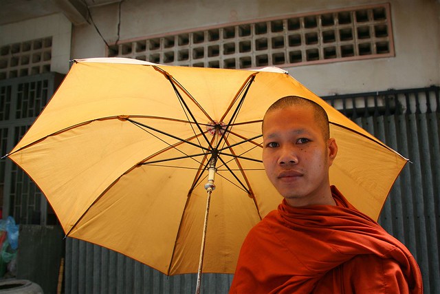 Cambodian monk walking in the street with umbrella, Phnom Penh province, Phnom Penh, Cambodia