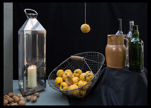 Quince, basket, candle lantern, walnuts