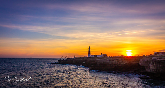 The sun just sitting above by Portland Bill Lighthouse, Dorset.