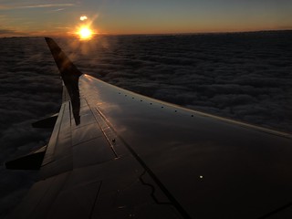 plane wing at sunset dramatic lighting