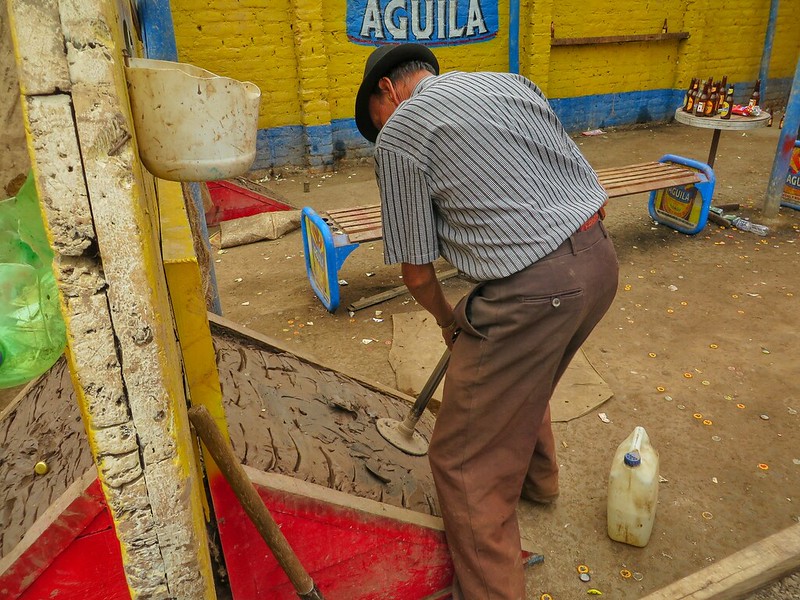 A man stamps down the clay on a Tejo board in Bogota, Colombia