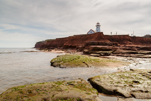 ocean red sea cliff lighthouse canada beach water rock stone point island coast sandstone prince atlantic east edward shore maritime end land pei cans2s