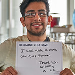 Student holding a sign thanking donors