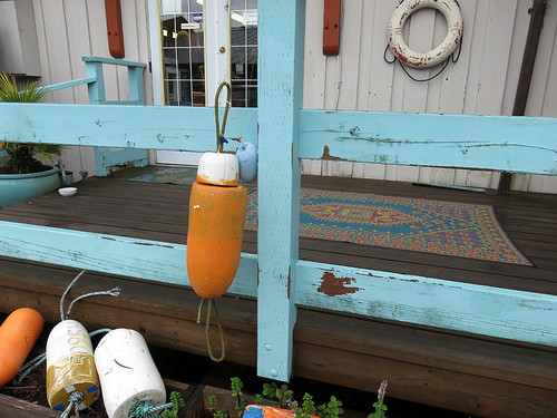 Turquoise railing & buoys decorate a shop in Tofino on Vancouver Island