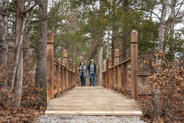 Couple hiking across the footbridge on Goodwin Lake Trail