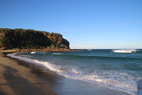 werribeach gerringong nsw australia beach sand surf waves surfer sunsetting afternoon headland
