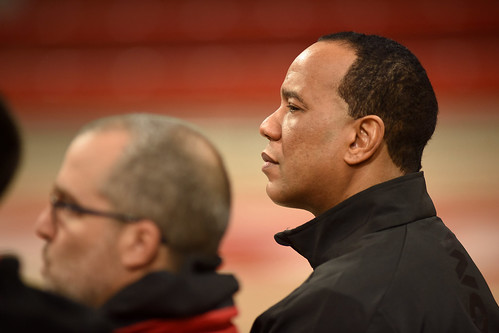 Men's basketball coach Kevin Keatts listens as new athletic director addresses media during a press conference.