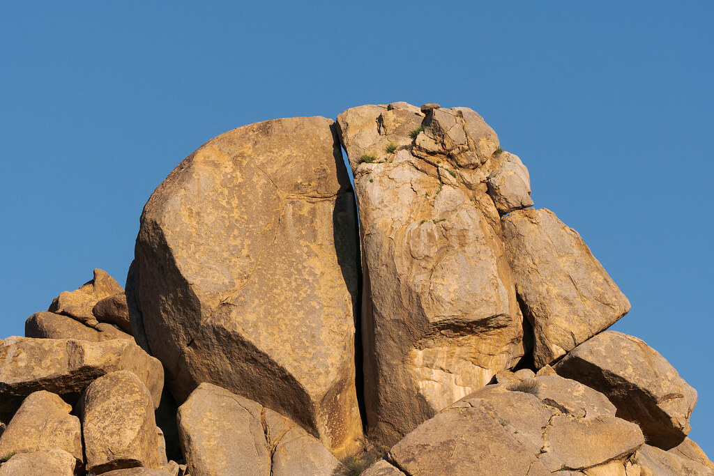 A distant view of a large red-tailed hawk's nest in the rocks high above the Sonoran Desert on the Marcus Landslide Trail in McDowell Sonoran Preserve in Scottsdale, Arizona