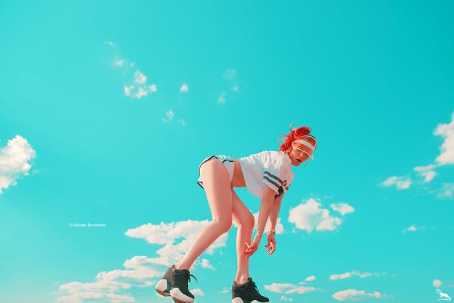 Sexy girl on the sky background, in short shorts - by Khusen Rustamov