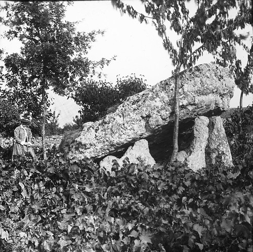 Woman standing beside large stone/dolmen by National Library of Ireland on The Commons, A few years ago we had a photo from the Mason Collection of the Brownshill Dolmen in Co Carlow.  I h