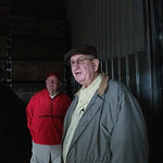 20190211-OSEC-LSC-0257 In a sweet potato warehouse, U.S. Department of Agriculture Secretary Sonny Perdue (red jacket) visits with one of the Warren Farming Partnership owners George Warren, in Newton Grove, NC, on February 11, 2019. Owner Brandon Warren (black vest), North Carolina Department of Agriculture Commissioner Steve Troxler (black leather jacket) and U.S. Representative David Rouzer (grey vest) joins the tour. The Warren family talk about the background and operation of the farm.as they tour the tobacco, and sweet potato production facilities. They join North Carolina Hog farmers for lunch. USDA Photo by Lance Cheung.