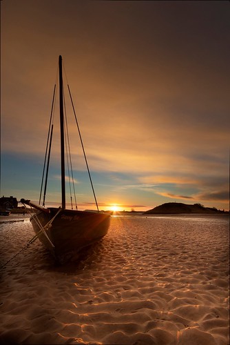 sunrise coastal sand northumberland alnmouth boats clouds orange uk england