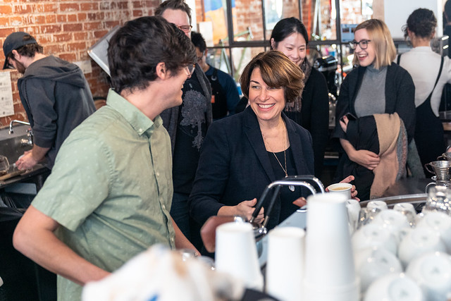 Senator Amy Klobuchar greets employees at Shift Cyclery and Coffee Bar in Eau Claire, Wisconsin