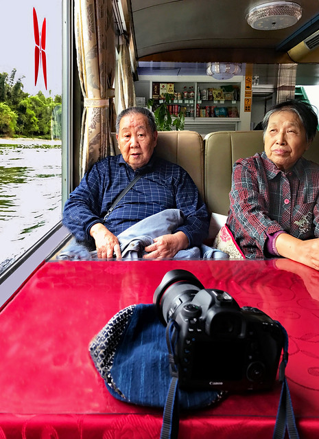 China. October 2017. Old Chinese tourist couple cruising on River Li.