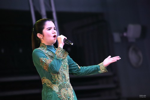 The image shows PWA Thara Marie Santiago singing wearing green dress.