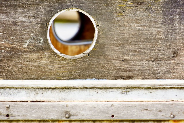 See thru hole in old wooden boat