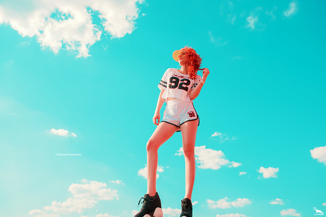 Sexy girl on the sky background, in short shorts - by Khusen Rustamov