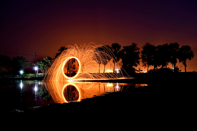 Lightpainting with steelwool and led, Steel wool photography it configured by Rotating burning steel wool,Spinning Wire Wool over the rock in dark sky