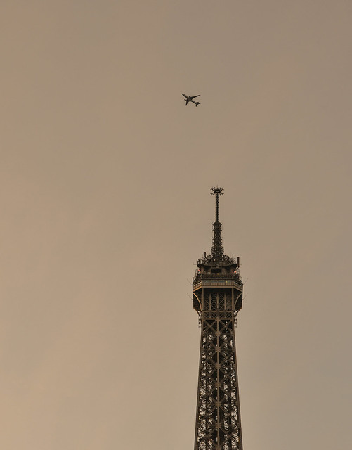 Airplane flying over Eiffel Tower