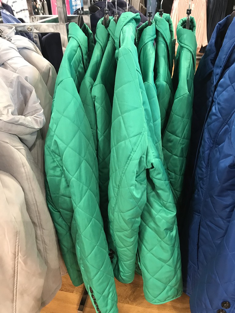 Green coats on display in Bon Marche shop | Hazel Nicholson | Flickr