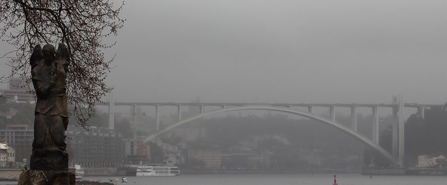 Porto arrabida bridge and statue foggy morning day