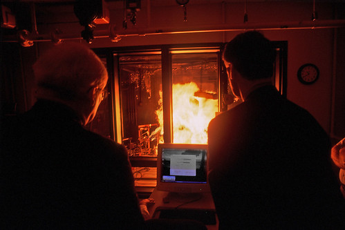 Congressman David Price (left) and Congressman Bob Etheridge get a firsthand viewing of Pyroman during during a 2002 visit to College of Textiles.