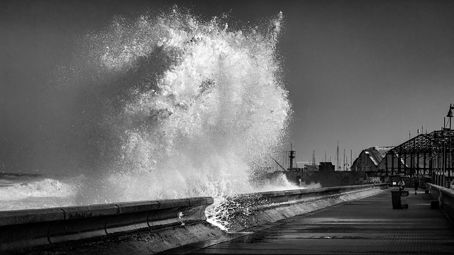 Crashing wave on wharf