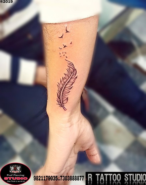 not as a tattoo, but on a wall | Feather tattoo meaning, Feather tattoos,  Feather with birds tattoo