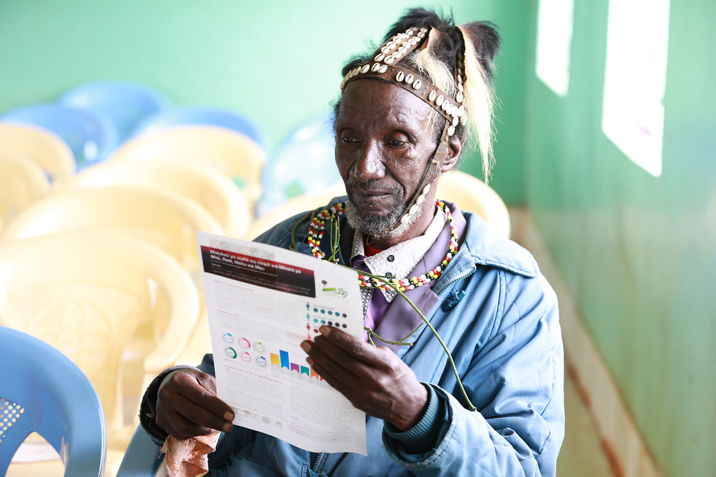 Village elder reading the Itare-Chemosit Sub-Catchment Management Plan (SCMP).