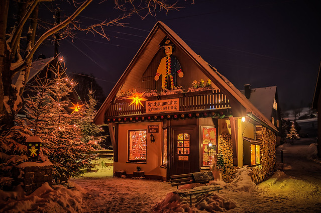 a little wood art shop at night in winter